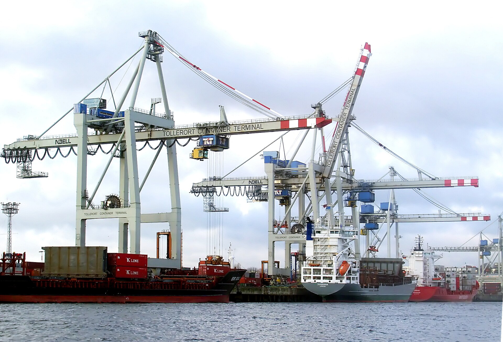 Modern industrial container shipping yard in Hamburg or Bremen with cranes and stacked containers